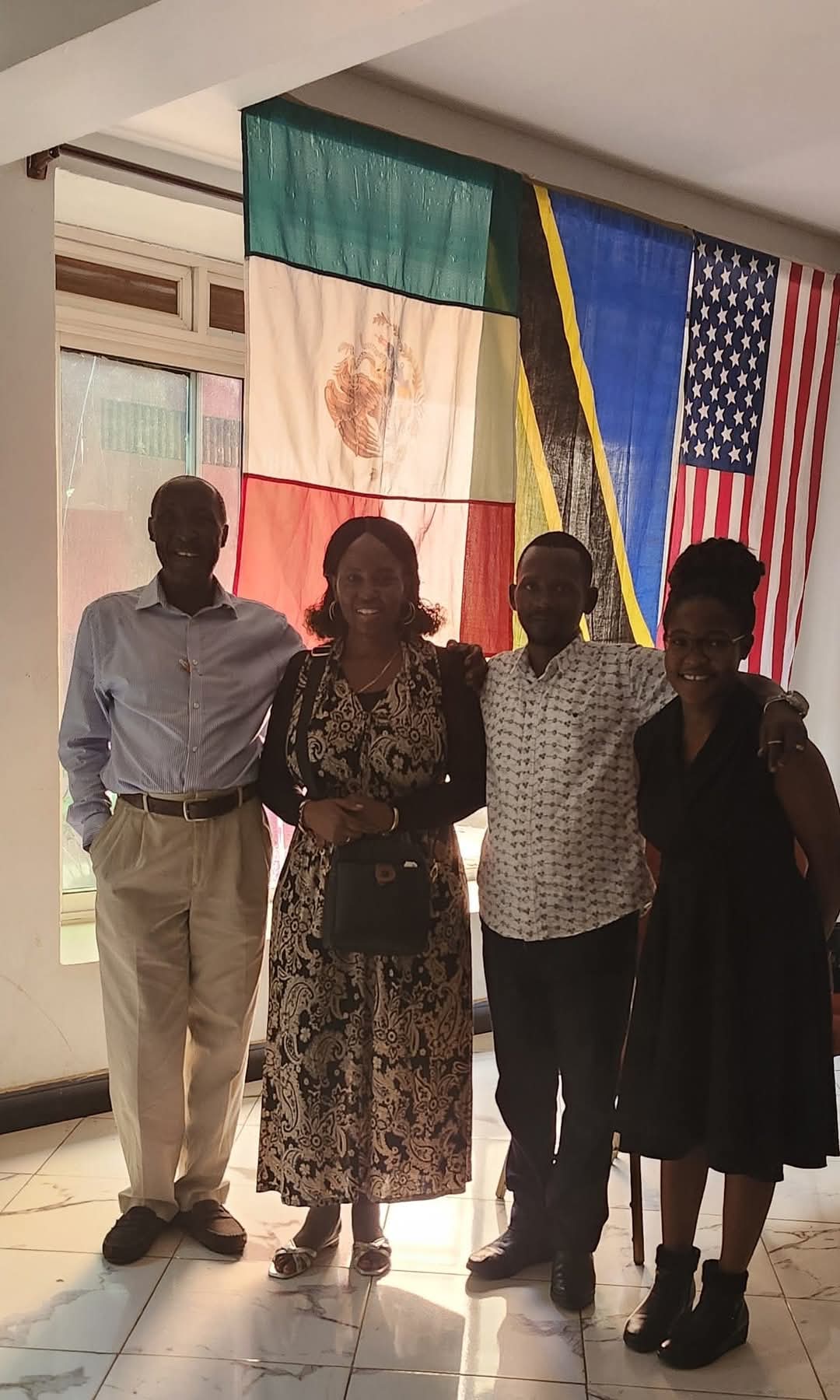 Dr. Apostle Benjamin Mwima and Dr. Imelda Mwima with flags representing KAI's global reach